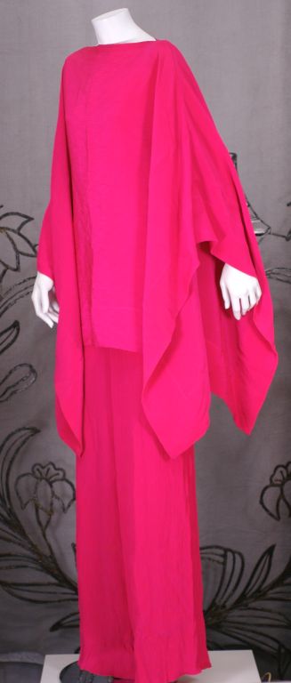 Chic, timeless Pauline Trigere vibrant Hot Pink Poncho pant Ensemble in crinkled silk crepe. Easy poncho top with elastic waist pant. 
Super versatile for many occasions. 1970's USA.
Poncho neck opening 12