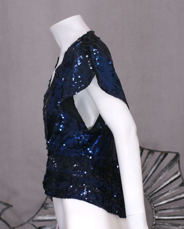 Midnight blue densely sequinned evening jacket with cap sleeves, deep armholes and fitted waist and peplum. Double breasted with hidden closures. Late 1930s.<br />
Excellent condition.<br />
Total length front : 19