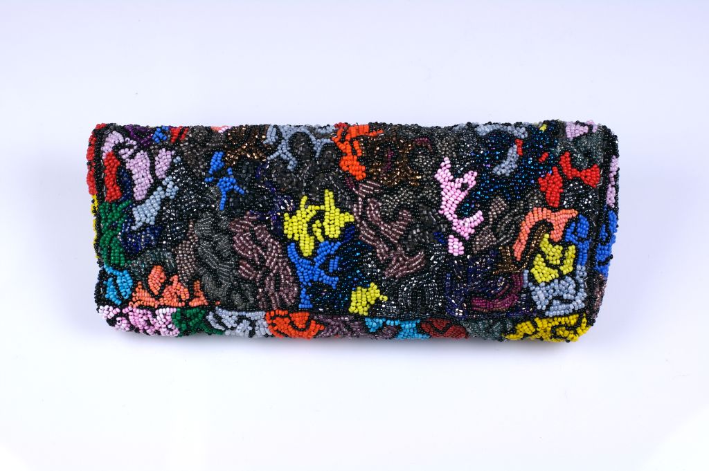 Vibrantly colored abstract patterned beaded clutch circa 1950s. Lined in blue and gold striped lurex from the period. Snap closure.<br />
Excellent condition<br />
9