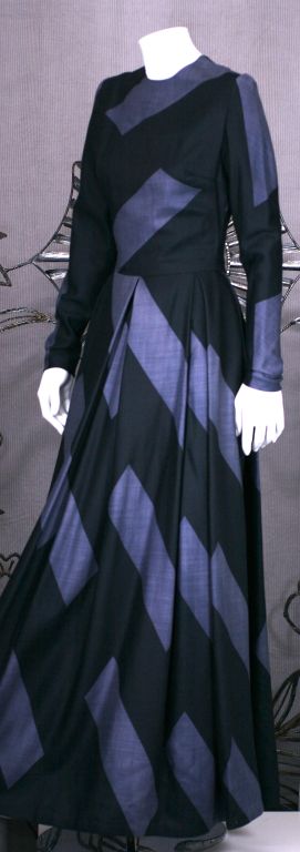 Unlabeled evening dress of the softest silk/cashmere twill. Graphic black diagonal stripe patterns on charcoal grey. Deep inverted pleats at the waist release to a very full skirt. Back zip entry. Undoubtedly a designer dress of the period.
Size