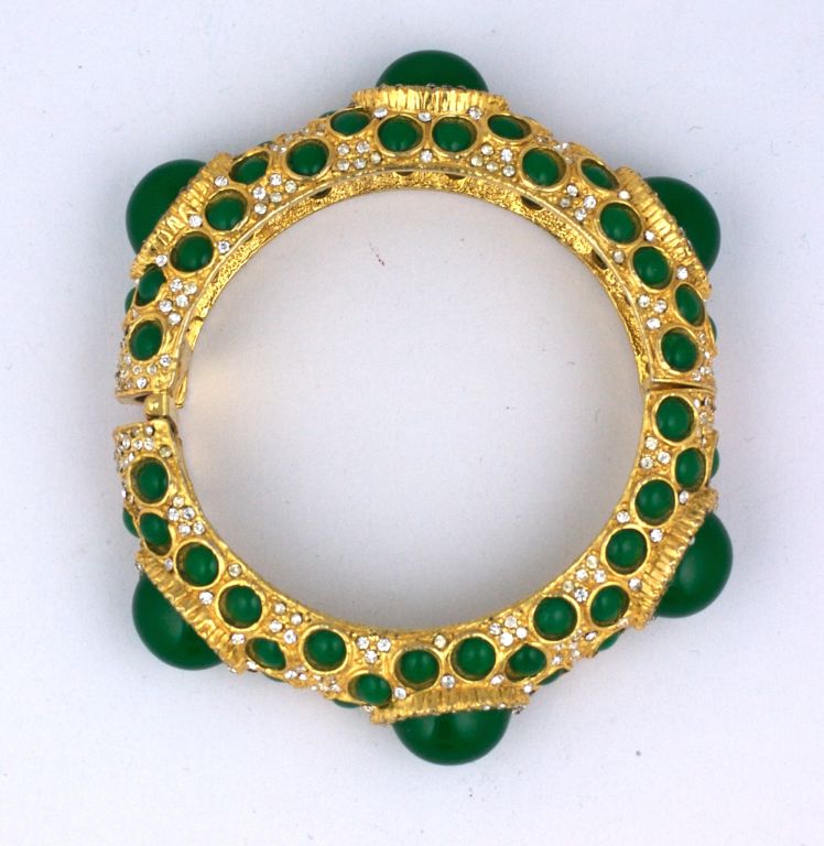 These KJL bangles were worn in multiples in the Vogue magazines of the 1960s. Kenneth Lanes fab faux renditions of fine jewelry of the period were de rigeur for fashionistas of the period. Cabochon faux jades are hand set into a goldtoned paveed