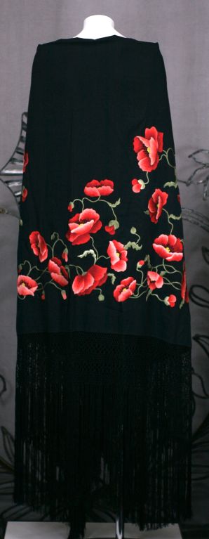 Extraordinary hand embroidered shawl dates from the early 20th Century. Heavy black silk crepe is completely embroidered,covered with lifelike poppies in ombre ruby tones. Amazing  florals and foliage. Wonderful quality and embroidered to be