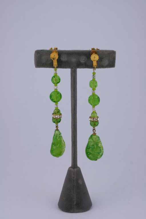 Miriam Haskell poured glass earring in a surreal shade of uranium green. So cool mixed with pave rhinestone spacers and russian gold beads at ear.<br />
Adjustable clip back<br />
Excellent condition<br />
Length:3 3/4 