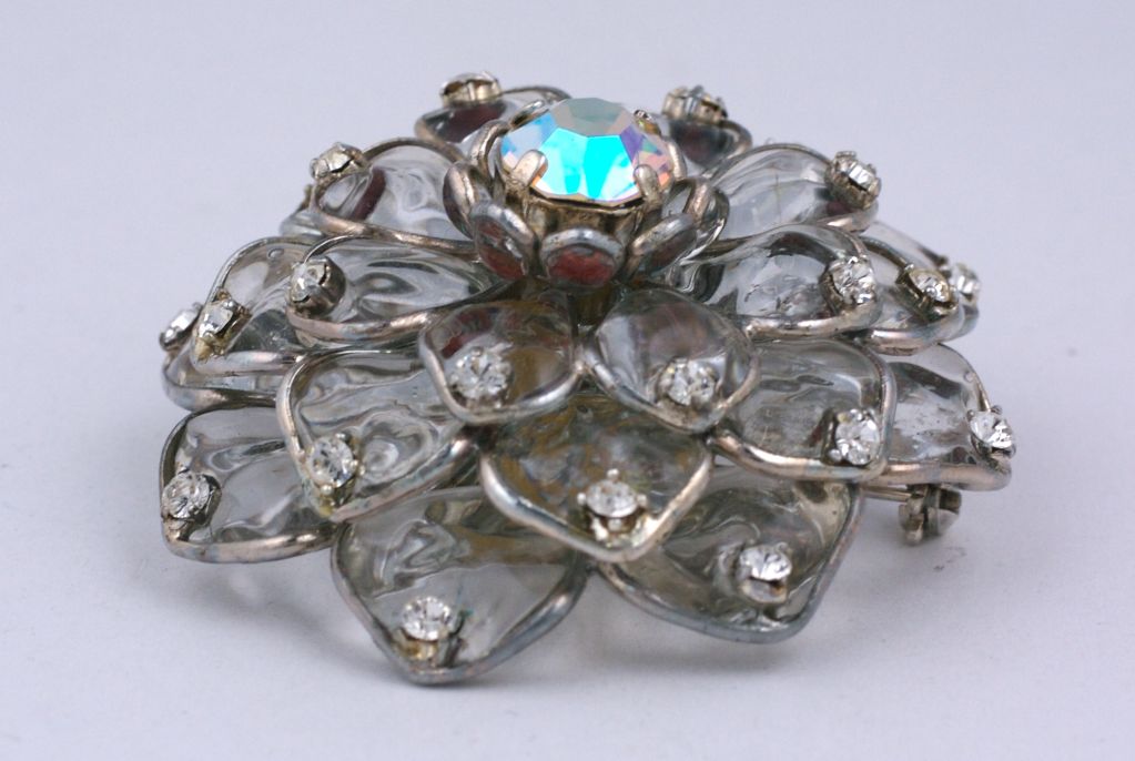 Handmade poured glass Zinnia brooch by Mark Walsh Leslie Chin. Crystal glass with pave accents at the tips of the petals.<br />
Has additional hook for pendant. Aurora Borealis center stone. Made in France.<br />
Images of Devon Aoiki in March