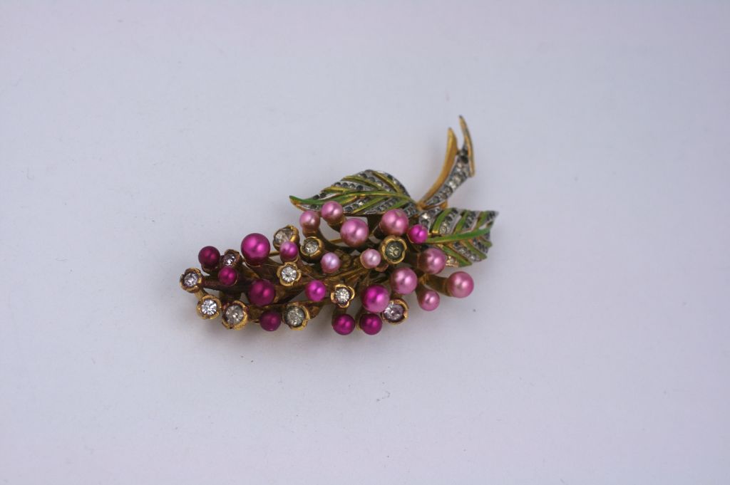 Unusual collectors piece by De Rosa. A retro style double prong fur clip of ombred faux pearl berries in fuschia with collet set glass rhinestones and lime green enameled leaves.
4