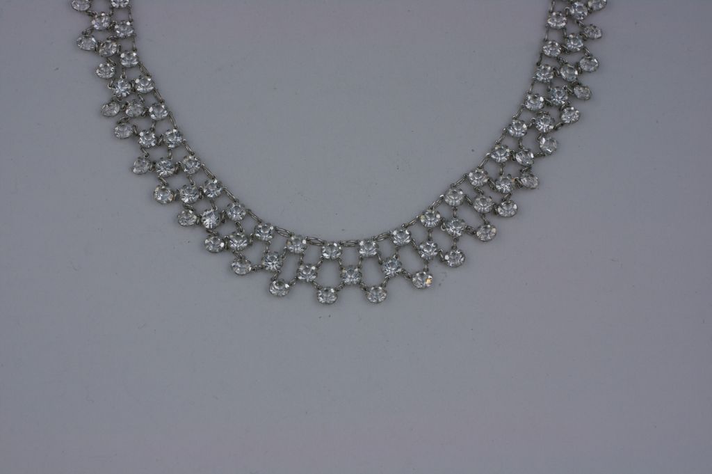 Art deco necklace constructed of a web of interlocking prong set crystals. Both delicate and striking at the same time.<br />
1920s USA.   Excellent condition.<br />
15.50