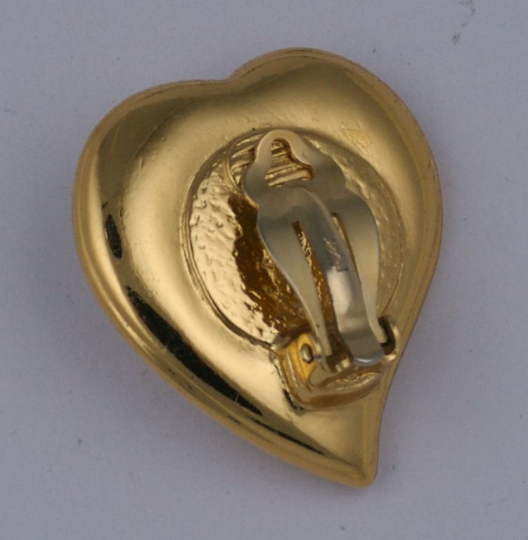 Pave heart clip earrings by YSL with large crystal cabochon.<br />
Excellent condition, 1990s<br />
1.5" x 1.25"