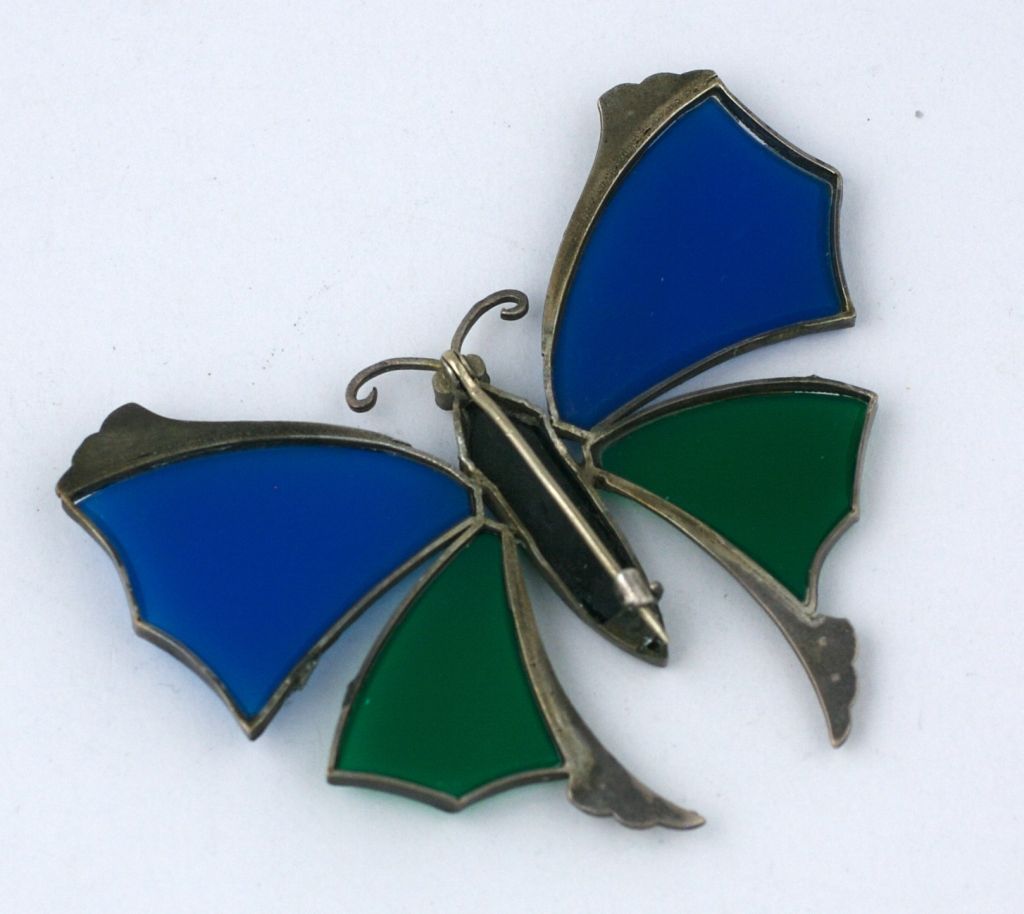 Colorful butterfly brooch from the deco period set with colored stones and marcasites in sterling silver. Genuine blue chalcedony and green onyx "stones" were cut to form the wings of this charming brooch.<br />
Excellent conidtion circa