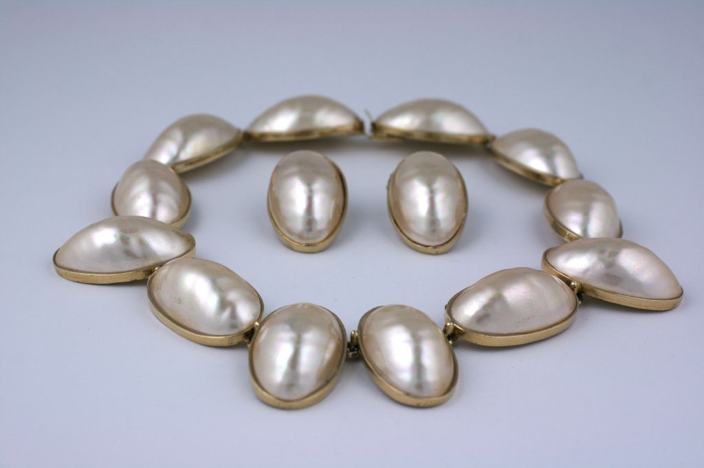Large faux mabe pearl demi suite by Kenneth Jay Lane set in gold toned metal.Matching clip earrings.<br />
Excellent condition