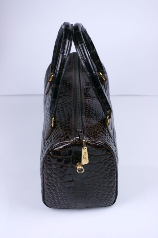 Beautiful quality Morabito, Paris mini duffle bag with detachable shoulder strap. Deep brown center cut alligator. Zipper entry. 1980s. Amazing quality and condition.
8.5