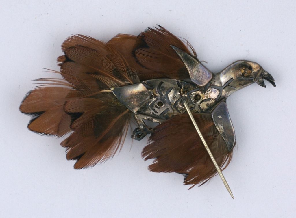 Unusual french paste bird stickpin set with rhinestones in sterling. Dyed feathers are for plumage, from the 1930s. Black enamel beak and claws.  DOMESTIC SALES ONLY.
Excellent condition