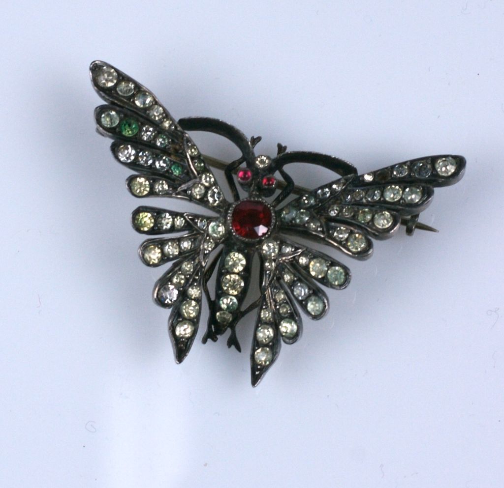 Lovely sterling butterfly brooch done in the Victorian era of clear and colored pastes. A large faux ruby forms the body and clear pastes stud the wings of the brooch. Heavy quality construction on this lovely period brooch made by a fine jeweler.
