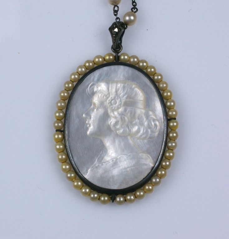 Wonderful art nouveau mother of pearl carving of period lady set into long sterling chain set with faux pearls meant to wrap around the neck several times. Marcasite accents on frame of cameo. Excellent condition, flapper length, 1920s.<br