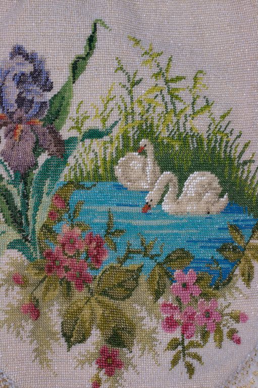 Incredible micro seed bead bag with figural panels of swans in floral beaded vignettes. The background is a pale pearly microbead. Extremely fine glass and metal beads are used to create the dimension in the pattern. Gold steel beads are used as an