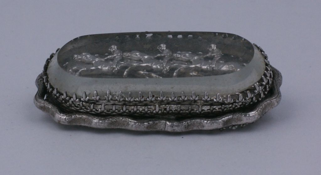 Unusual silverplate brooch from the late 19th Century.<br />
A series of jockeys are mounted on springs and they move within the glass enclosed vignette. Extremely unusual and charming. Thick hand cut crystal cover and faux branch surround.<br
