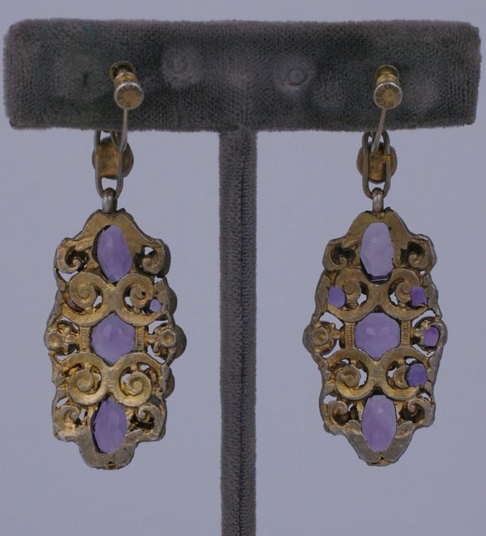 Unusual amethyst and pearl earrings from the early part of the 20th Century. Fancy cut amethysts and blister pearls are set in gilt silver with leaf decorations. Screw back fittings. Hungarian origin.<br />
2.5 x 7/8