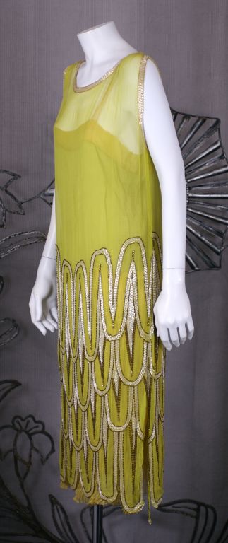 High style art deco beaded flapper dress from the 1920s France. Lovely and unusual chartreuse colored chiffon with beaded scale 