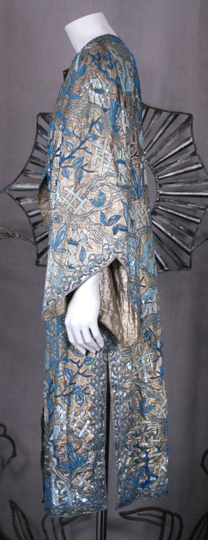 A finely beaded, sequined  and embroidered evening coat, attributed to Margaine Lacroix, mid 1920's Paris, in extraordinary condition. 
The muted silver lamé ground is covered with hand beaded and sequined Asian figures set in landscapes of