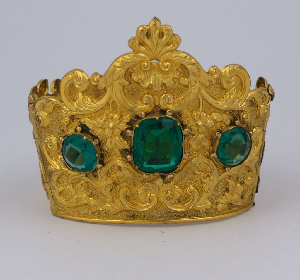 Impressive roccoco cuff in crown form with round and cushion cut emerald pastes. Beautiful quality pinchbeck with hand repousee and etched workmanship. Extremely french in design. Mid 19th Century France. Hinged with double ball decorated clasp.