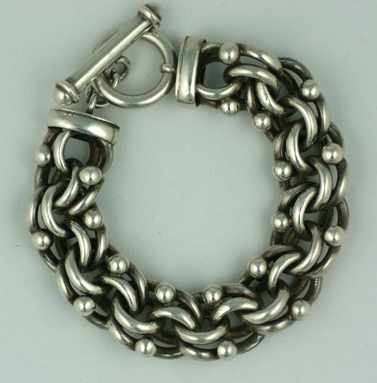 Large,chunky and heavy sterling bracelet suitable for both men or women. Ornate looped links are capped by ball motifs for a deco styled bracelet.

7.5