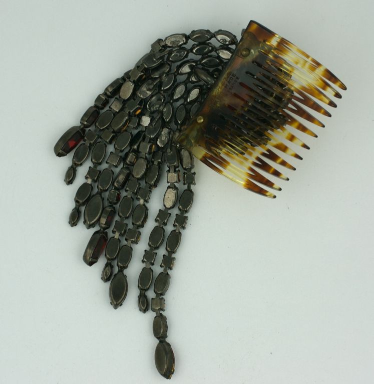 Roger Jean Pierre swirled hair comb of deep ruby navette and round rhinestones in articulated settings. Meant to be worn at an angle for maximum effect and movement. Roger Jean Pierre worked for many Haute Couture houses in Paris creating jewelry