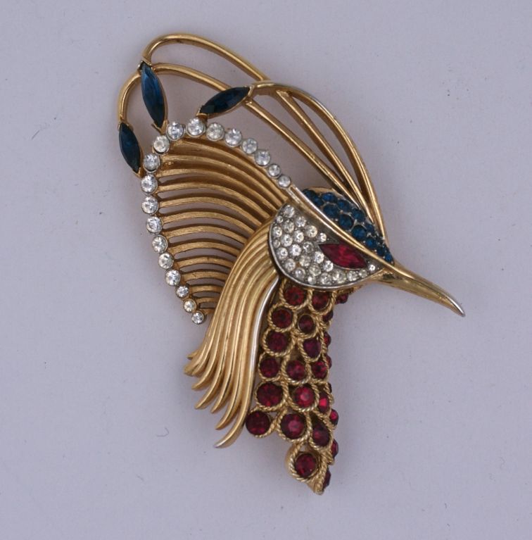 Dramatically designed Trifari exotic bird head brooch with ruby, sapphire and crystal pastes set into gold toned metal. 1960s USA.
Excellent condition. 3