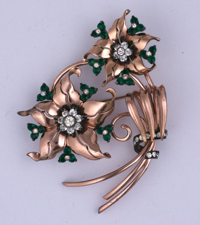 Amazing massive sterling spray with a pink gold wash by Pennino from the 1940s. Clear and green pastes accent this 3D floral spray. Pennino was well renown for its amazing renditions of  40s fine jewlery of the period. This spray is an example of