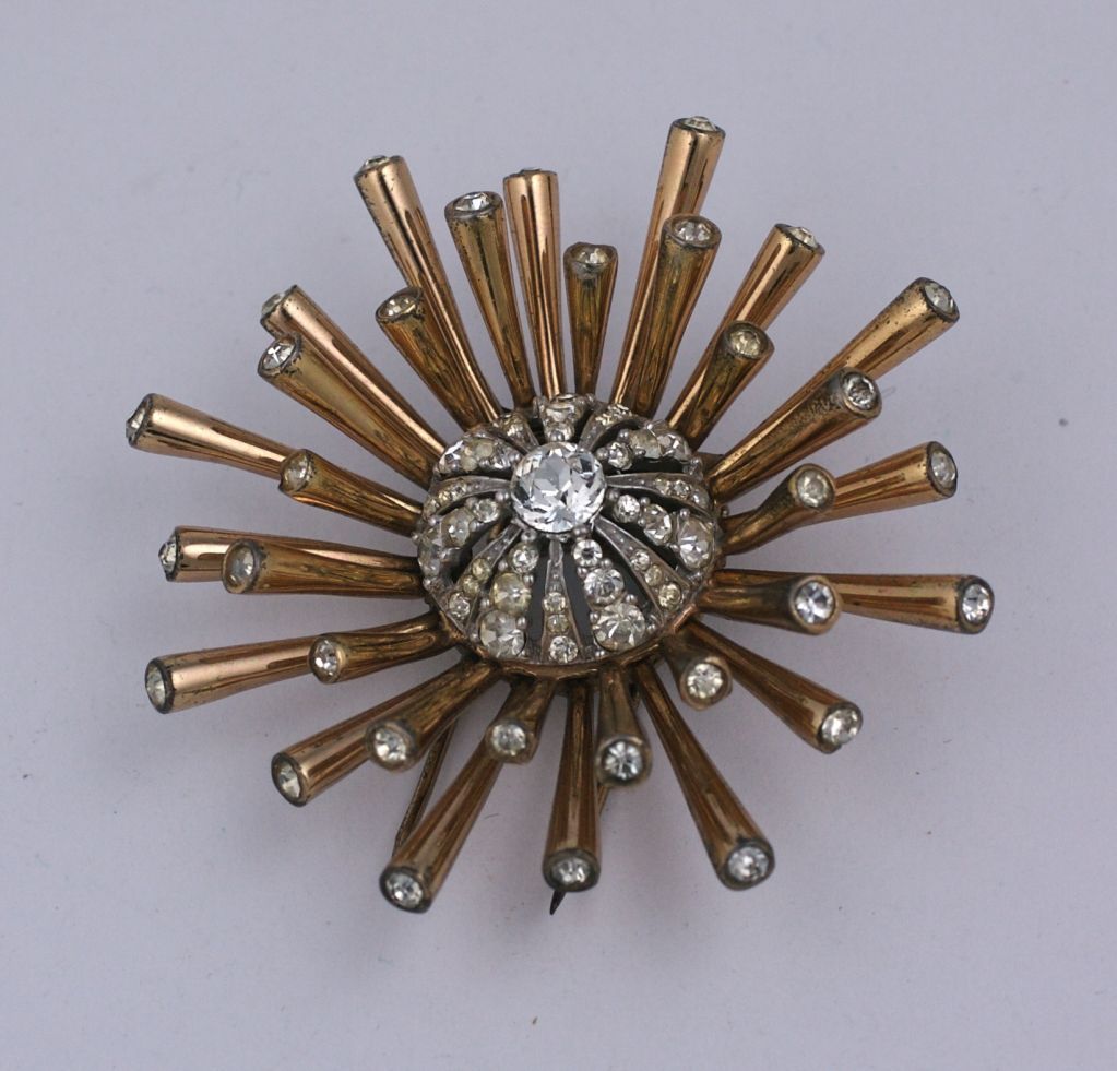 Early Marcel Boucher clip brooch from the late 30s early 1940s. Designed as a very 3 dimensional sputnik with a pave domed center. Double prong fur clip fitting. Gilded sterling 1940s USA.<br />
Striking, dimensional and amazing quality.<br