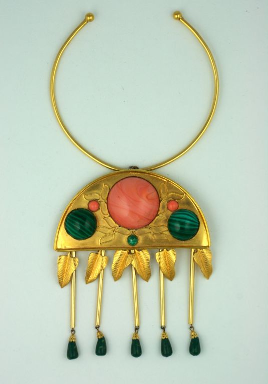 Imposing ethnic/ancient style pendant necklace from the 1960s by William DeLillo. Goldtoned metal with cabochons and drops of faux coral and malachite.<br />
Necklet wire collar size: small<br />
Excellent condition.