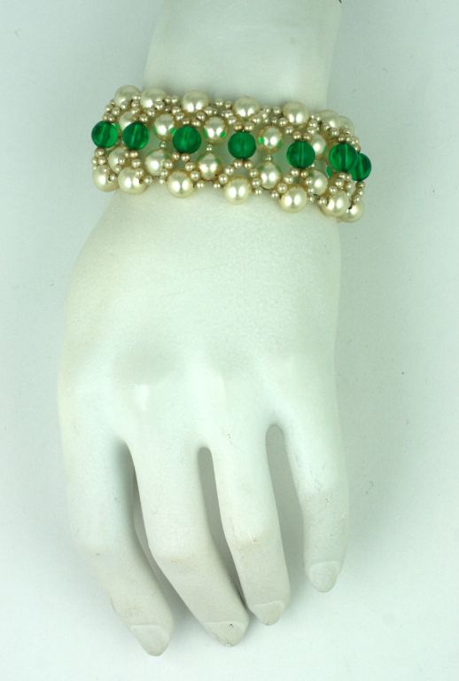 Elaborate woven bracelet by Louis Rousselet, Paris circa 1940s. High quality faux pearls and emerald pate de verre beads are used for this bracelet and earring combination.
Excellent condition.