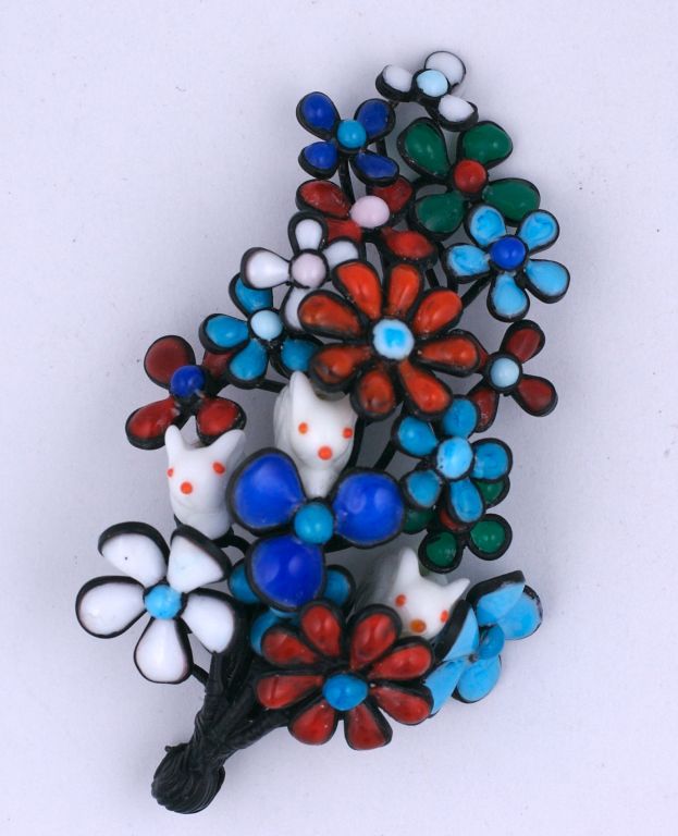 Oversized Brooch of 3 glass lampwork bunnies trembling within a burnt floral bouquet of newly iridiated blooms and held in place by a blackened eagle's talon. Handmade poured glass enamel brooch taking over two weeks to construct by hand by a single