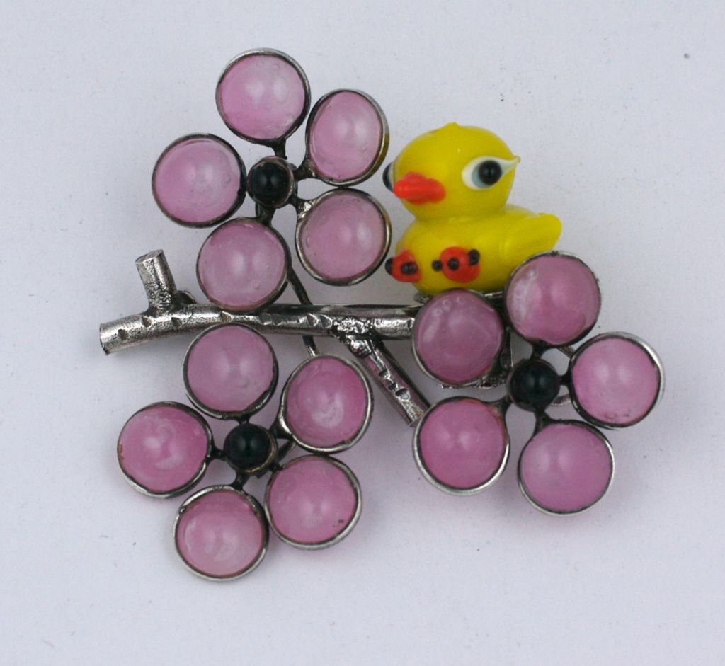 Lampwork glass duckling on a poured glass bough of pale pink cherry blossoms and silvered metal by Mark Walsh Leslie Chin.

Completely made by hand in our studios in France. 2.25