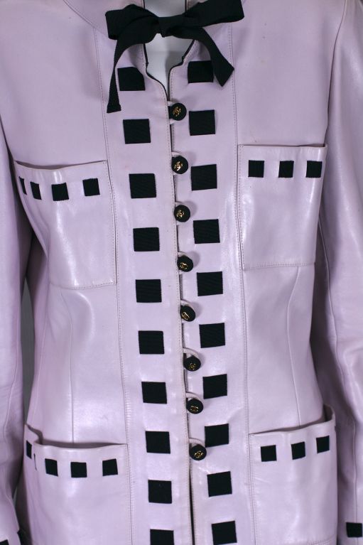 Iconic Chanel Pale Lilac Pink Lambskin Leather and Grosgrain ribbon jacket by Karl Lagerfeld for Chanel. Stand away collar with grosgrain ribbon details threaded thru all the edges and pockets. 
