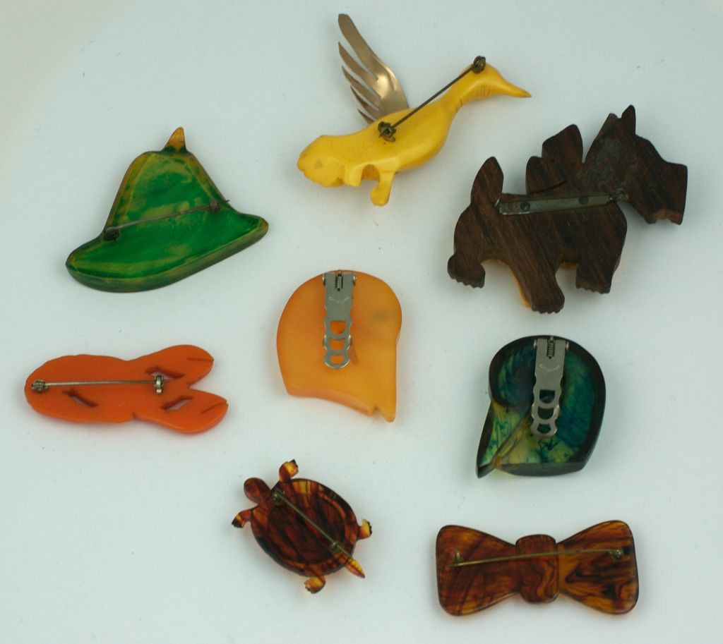 Charming selection of bakelite figural brooches with different treatments and techniques. All hand carved and hail from the Art Deco Period, American.<br />
All Excellent condition.<br />
Tyrolean hat: Stained and Painted Bakelite (2.5