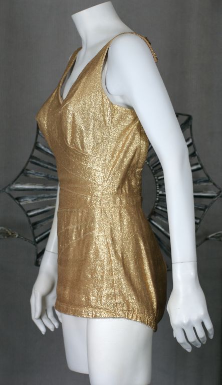 Not intentionally designed for swimming but more for cocktails under the cabana. Pieced gold lame sections slim the waist. Button accented straps and racy industrial back zipper. This suit builds in the pin up body you never had.<br />
excellent