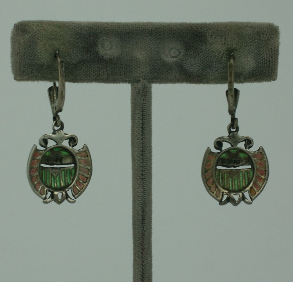 Unusual and rare earrings in a scarab motif set in sterling with marcasites.The body and wings are in lovely plique a jour (transparent)enamel which allows light to pass through.<br />
Eygptian revival style from the 1930s.<br />
Excellent