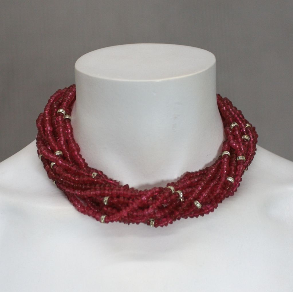 Wonderful Ruby pate de verre multistrand bead necklace by Ciner, NY. Pave rondel spacers add interest to the pave clasp.

Wonderful quality and heft. 1980s. 15.5