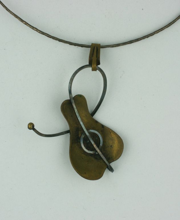 This pendant is a miniature sculpture, a reflection of the clean edged,atomic designs of the great 1950s American Studio Artist-Jewelers. Paul Lobel worked in brass and sterling to create a this miniature mobile for the neck.<br />
Excellent