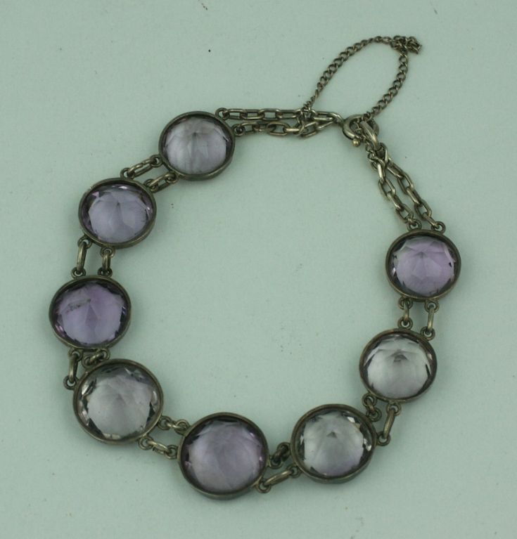 Genuine amythests set in sterling bezels form this bracelet from the 1930s. Stones are slighted graduated to largest size in center ranging from 12-15mm. Wonderful condition and tonal variations in stones.
Approx. 7.5