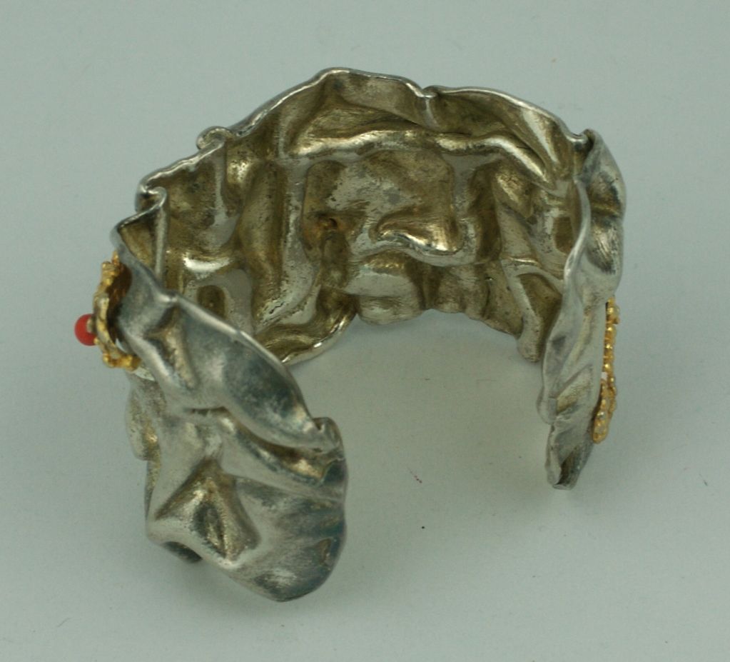 Unusual artisanal cuff of "crumpled" silvered metal with a gilt detail trim with coral glass beads.<br />
2" height  6.5" length<br />
Excellent Condition, circa 1980s.