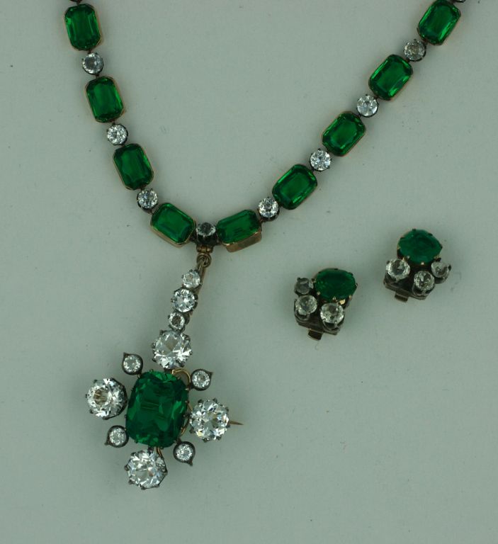 Lovely emerald and clear paste pendant necklace. Set in heavy 9K gold openback settings. The clear pastes are set in silver topped gold to replicate diamond jewelry from the same period. Drop is detachable and can be worn as a brooch as well. Small