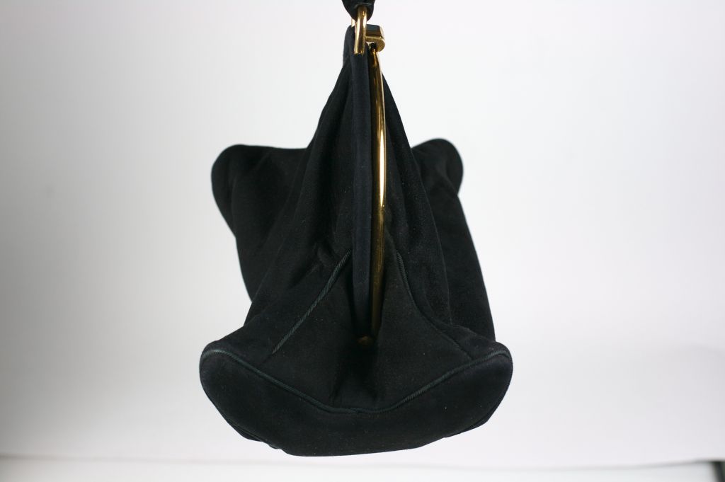 Unusual black suede doeskin wrist bag by Rosenfeld NY. Charming and novel shape with a four curled points on the base.
Handle 8