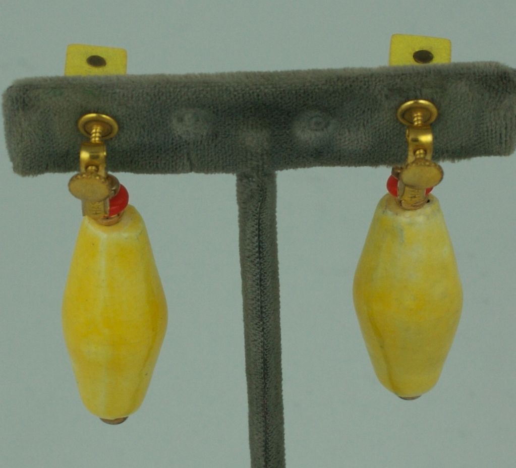 Miriam Haskell rare resort earring of yellow wood , orange glass and hand made yellow glazed ceramic .<br />
 length 3