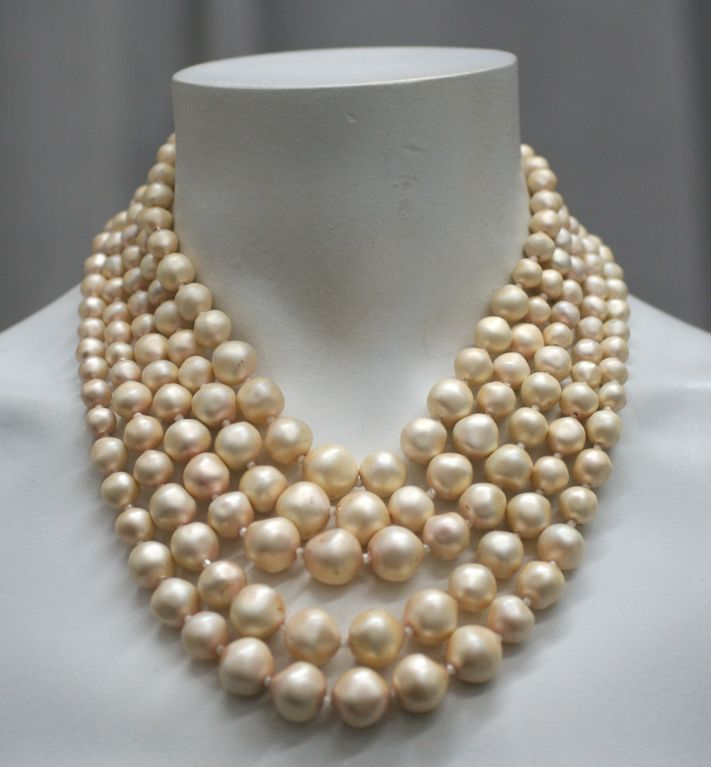 Schiaparelli graduated faux pearls with blue aurora cabochon and rhinestones.1950s.<br />
Pearl color is closer to images on mannequin. <br />
Excellent condition<br />
Beads measure 15.5