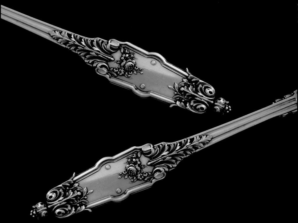 Exceptional Strawberry spoon with embellishments. The silver-gilded bowl is of stylized scallop shell form, The handle has Louis XVI style with foliages and flowers motifs. This strawberry spoon is plate n°50 of the Maison Puiforcat catalogue, and