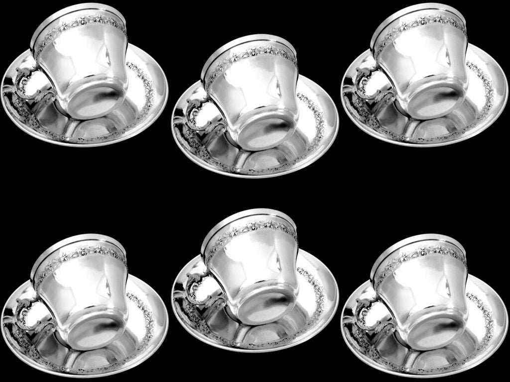 Exceptional and rare service 6 pc of French Sterling Silver Tea/Coffee/Chocolate, including six cups in all sterling silver and vermeil interior and six matching saucers in sterling silver. The set has Iris motif, Art Nouveau inspired scrolls