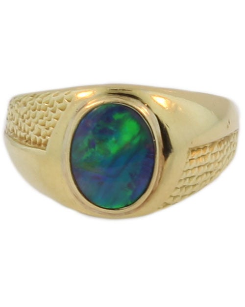 This ring is clearly stamped 750 which is the European mark for 18KT gold. It contains an exceptional black opal which reflects bright shocks of green and blue. The cabochon opal measures 10.3 x 8 x 4.15 mm. The back of the ring shows the matrix of
