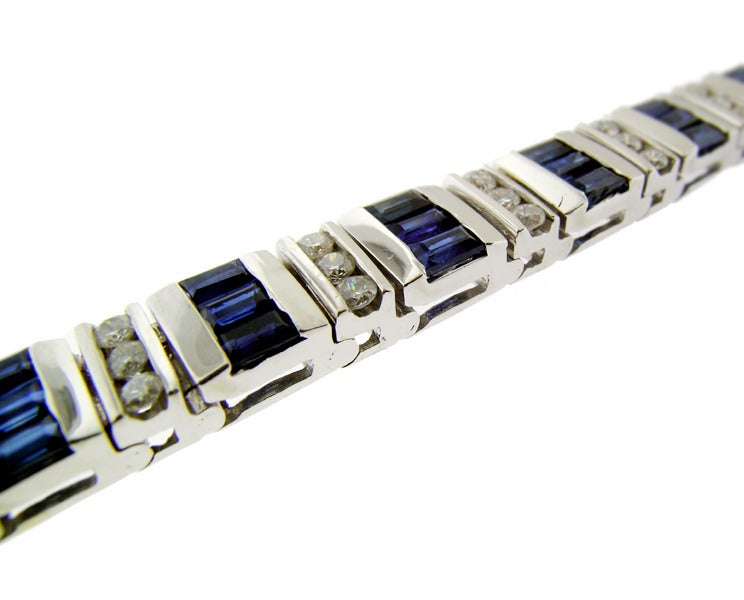 This bracelet is set in 14 KT white gold. It contains 6 cts of rectangular step cut sapphires and approximately 1.70 cts of round brilliant cut diamonds. The bracelet measures 7 inches and it is excellent condition.