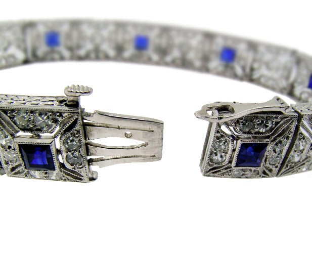 This bracelet is set in platinum which has been tested. It is hand made and has extremely fine cut and filigree work. The bracelet is set with approximately 3 cts of sapphires and 3 cts of old mine cut diamonds. It is in excellent condition and