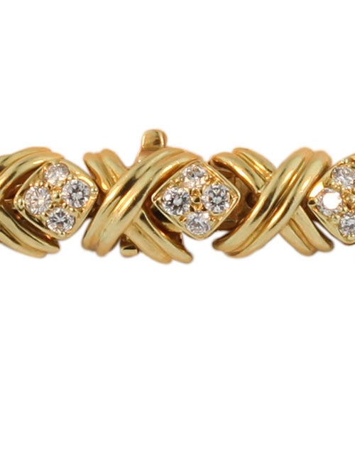 This bracelet is clearly signed Tiffany & Co. and was designed Jean Schlumberger. It features 3 cts of excellent quality diamonds and is set in 18KT yellow gold. The bracelet measures 7 inches.